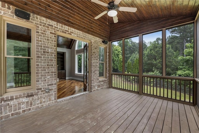 unfurnished sunroom with a ceiling fan and lofted ceiling