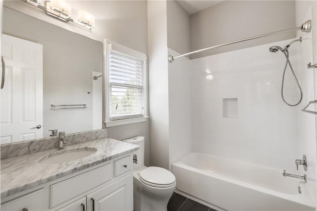full bath featuring toilet, vanity, and bathtub / shower combination