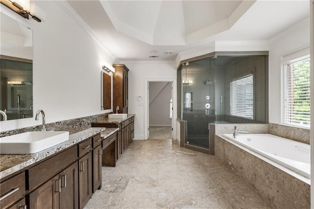 full bath with double vanity, a stall shower, a garden tub, and crown molding