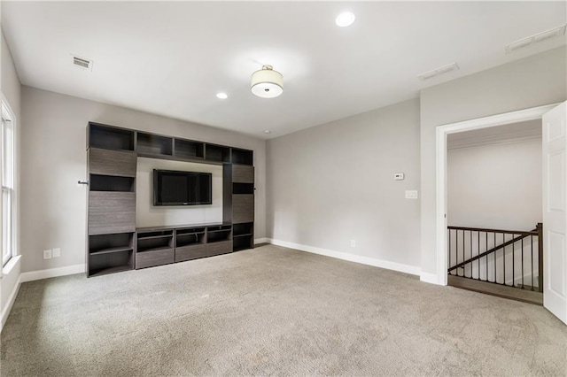 unfurnished living room with carpet floors, baseboards, and recessed lighting