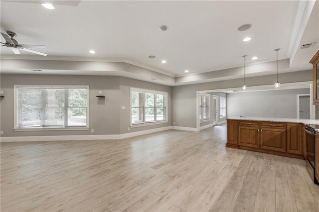 unfurnished living room featuring ornamental molding, light wood finished floors, a tray ceiling, ceiling fan, and baseboards