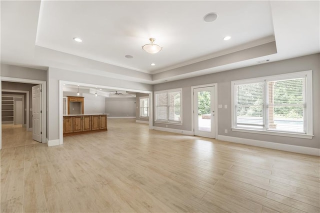 16720 Quayside Dr, Alpharetta, GA 30004 - unfurnished living room featuring a raised ceiling, baseboards, light wood finished floors, and recessed lighting