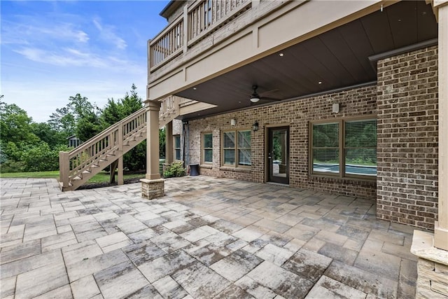 view of patio / terrace with stairway and a ceiling fan