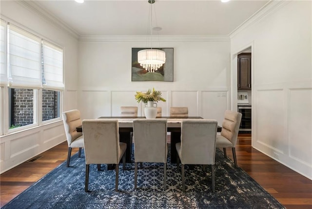 16720 Quayside Dr, Alpharetta, GA 30004 - dining space featuring a decorative wall, dark wood finished floors, a chandelier, ornamental molding, and wainscoting