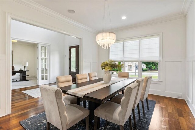 16720 Quayside Dr, Alpharetta, GA 30004 - dining area with a decorative wall, a chandelier, dark wood finished floors, ornamental molding, and a wainscoted wall
