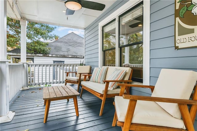 deck with an outdoor living space and ceiling fan