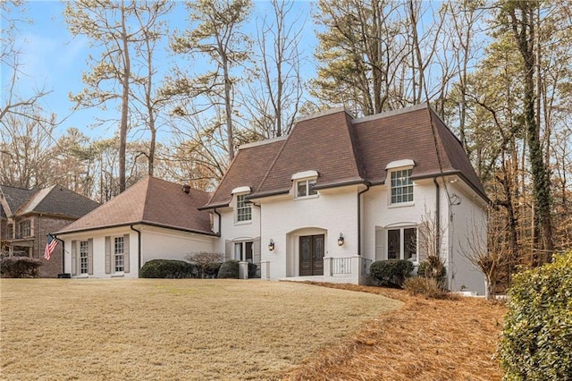 french provincial home featuring french doors, central AC unit, and a front yard