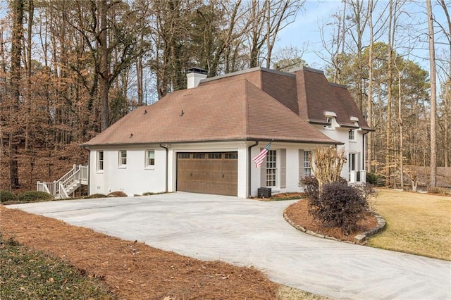 view of home's exterior featuring a garage and a yard