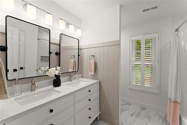 4433 Windsor Oaks Cir, Marietta, GA 30066 - full bathroom with marble look tile flooring, double vanity, and baseboards