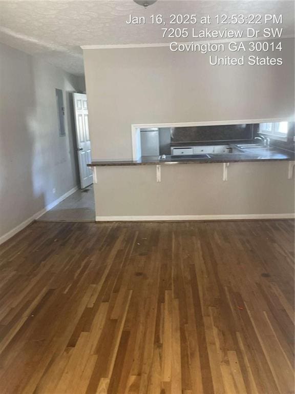 interior space featuring sink, a textured ceiling, and dark hardwood / wood-style flooring