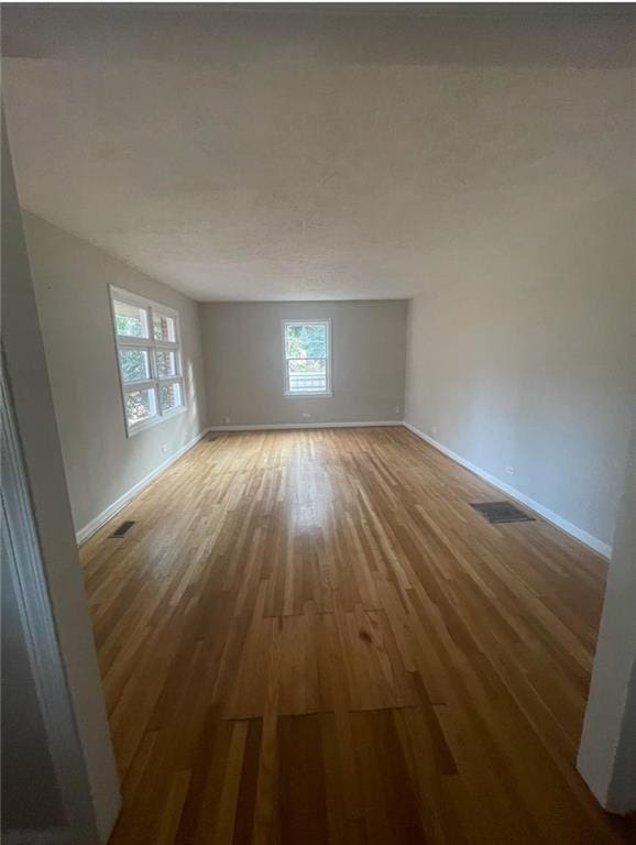 empty room with wood-type flooring