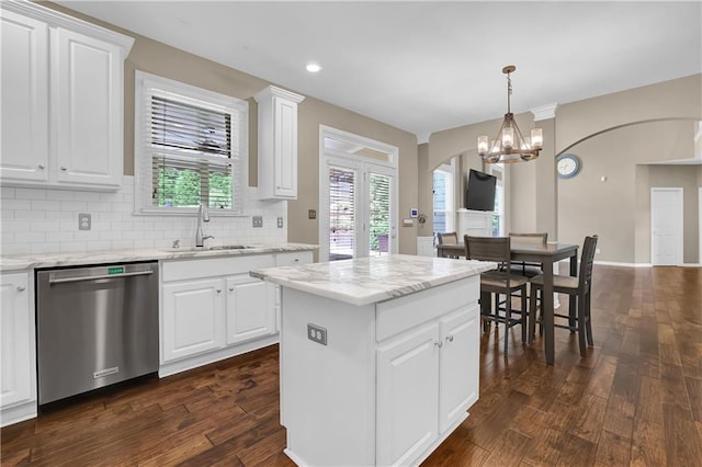 kitchen featuring dark wood-type flooring, a kitchen island, sink, and stainless steel dishwasher