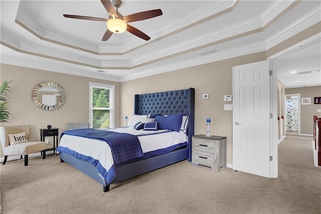 bedroom with crown molding, ceiling fan, a tray ceiling, and carpet