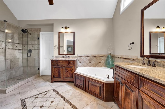 bathroom featuring vanity, lofted ceiling, tile patterned flooring, and separate shower and tub