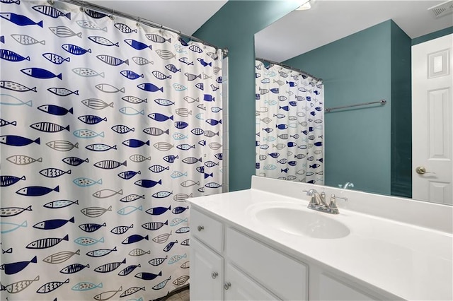 bathroom with walk in shower and vanity