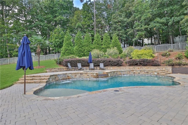 view of pool with a patio, a yard, and pool water feature