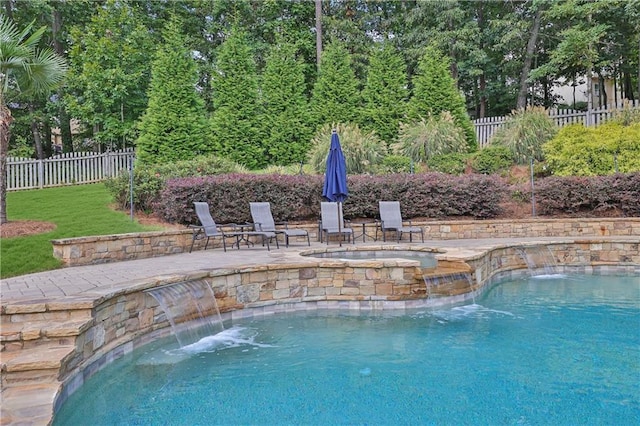 view of swimming pool featuring an in ground hot tub, a lawn, a patio area, and pool water feature