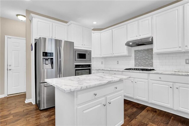 kitchen with appliances with stainless steel finishes, a center island, dark hardwood / wood-style flooring, and white cabinetry