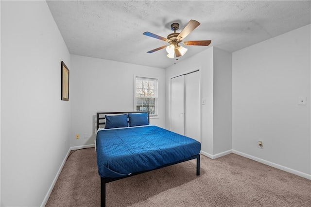 2858 Spring Villa Ln SE, Smyrna, GA 30080 - bedroom with baseboards, carpet floors, a textured ceiling, ceiling fan, and a closet