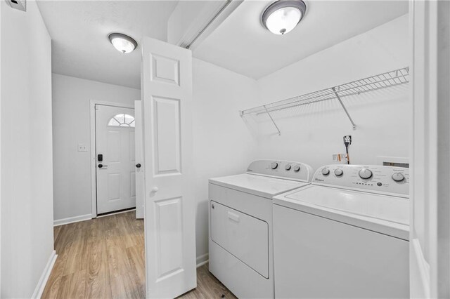 2858 Spring Villa Ln SE, Smyrna, GA 30080 - laundry room featuring separate washer and dryer, light wood finished floors, and baseboards