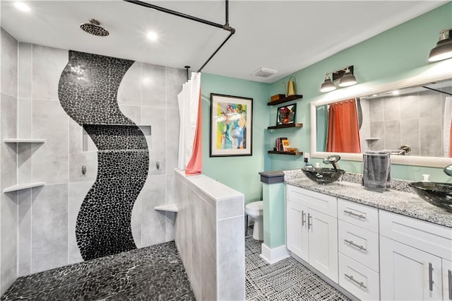 bathroom with tile patterned floors, curtained shower, vanity, and toilet