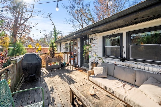 deck with grilling area and an outdoor living space