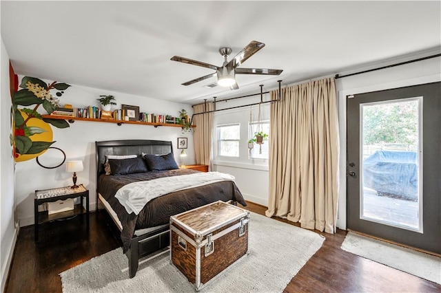 bedroom with multiple windows, ceiling fan, and dark wood-type flooring