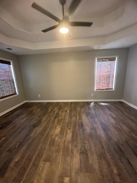 1732 Wyntercreek Ln, Hoschton, GA 30548 - unfurnished room featuring dark wood finished floors, a ceiling fan, and a healthy amount of sunlight