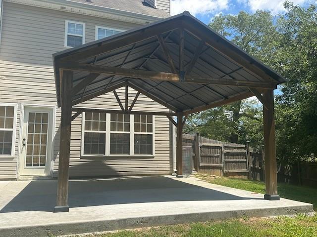 1732 Wyntercreek Ln, Hoschton, GA 30548 - view of side of home with a chimney and fence