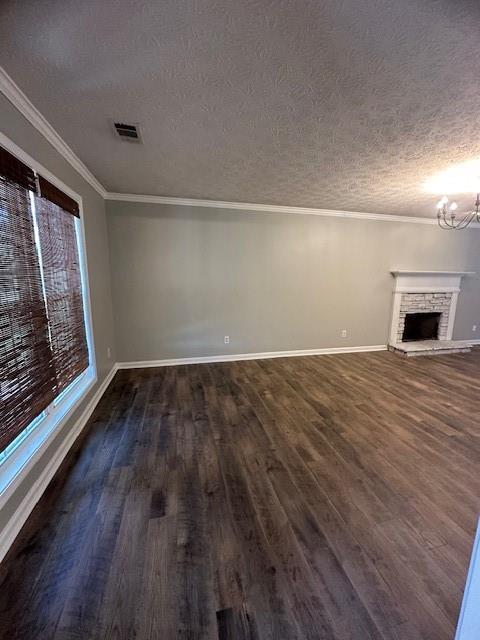 1732 Wyntercreek Ln, Hoschton, GA 30548 - unfurnished living room with a textured ceiling, a notable chandelier, dark wood-type flooring, and baseboards