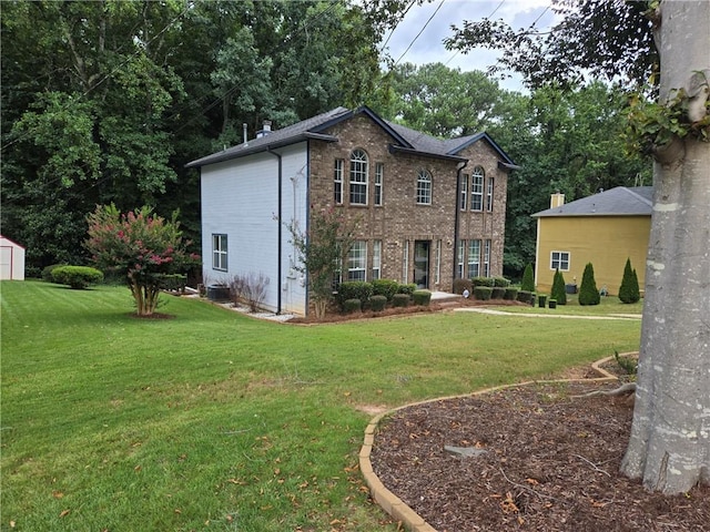 view of front of house featuring brick siding, central AC unit, and a front lawn