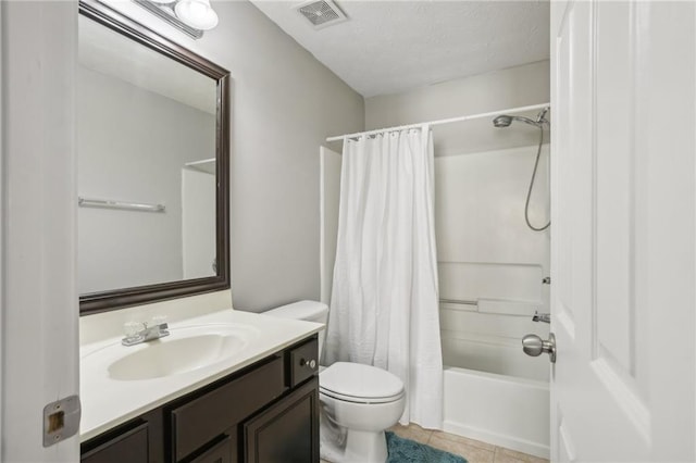 full bathroom with shower / bath combo, tile patterned flooring, a textured ceiling, toilet, and vanity