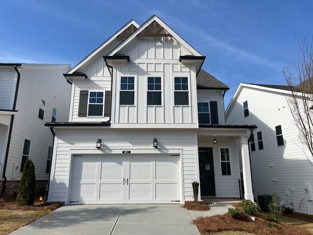 view of front facade with a garage, board and batten siding, and concrete driveway