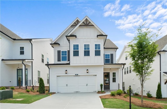 636 Silva St, Cumming, GA 30040 - view of front of home featuring board and batten siding, driveway, and a garage