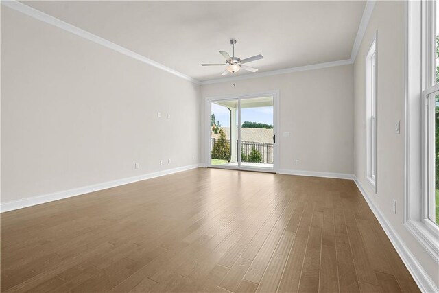 636 Silva St, Cumming, GA 30040 - empty room with ceiling fan, dark wood-style flooring, baseboards, and crown molding