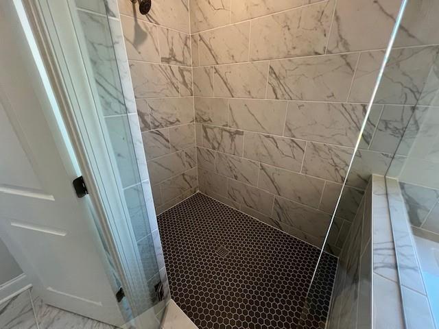 full bath with a tile shower