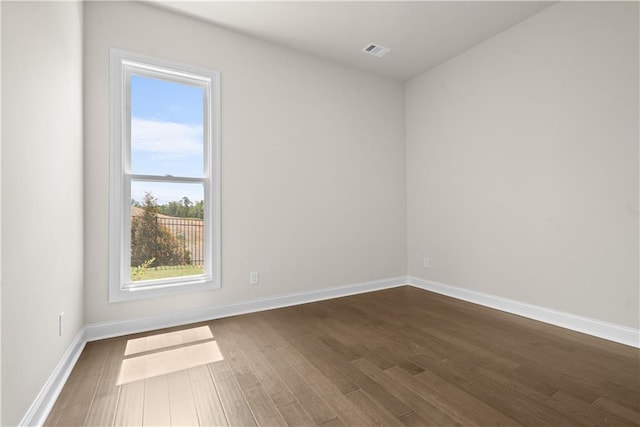 636 Silva St, Cumming, GA 30040 - spare room featuring dark wood finished floors and baseboards