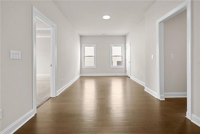 636 Silva St, Cumming, GA 30040 - empty room featuring baseboards and dark wood-type flooring