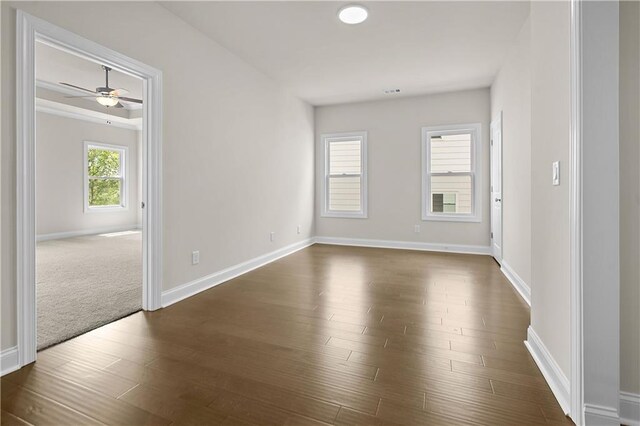 636 Silva St, Cumming, GA 30040 - empty room with dark wood finished floors, baseboards, and a ceiling fan