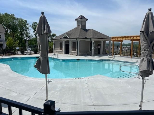 pool featuring a patio and fence