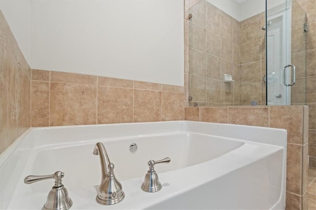 bathroom with separate shower and tub