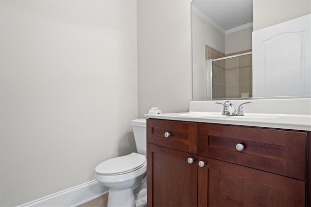 bathroom featuring an enclosed shower, vanity, ornamental molding, and toilet