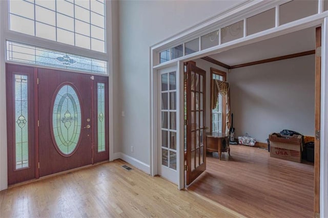 516 Turner Rd, Concord, GA 30206 - foyer entrance with french doors, wood finished floors, baseboards, a high ceiling, and crown molding