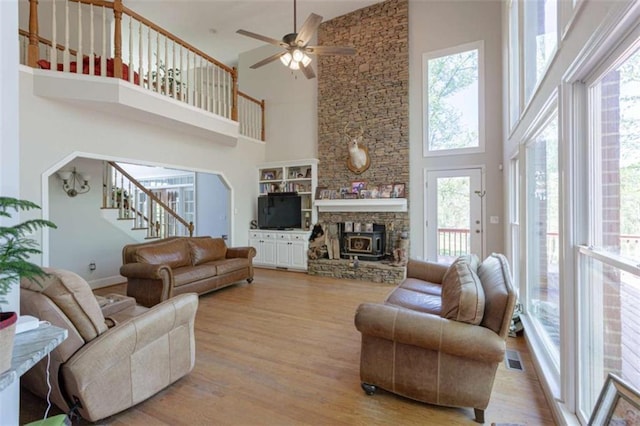 516 Turner Rd, Concord, GA 30206 - living area featuring high vaulted ceiling, wood finished floors, a ceiling fan, stairway, and a fireplace