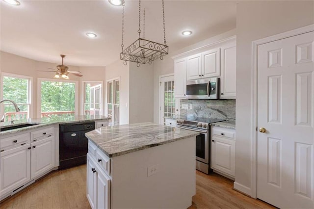 516 Turner Rd, Concord, GA 30206 - kitchen with appliances with stainless steel finishes, a sink, a center island, tasteful backsplash, and light wood-type flooring