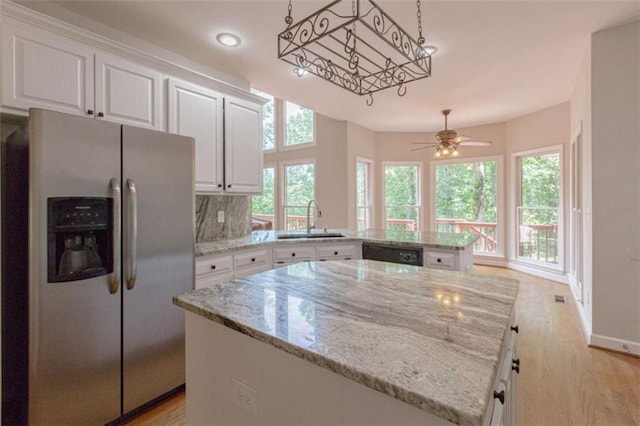 516 Turner Rd, Concord, GA 30206 - kitchen featuring stainless steel fridge, a sink, dishwasher, white cabinetry, and a peninsula
