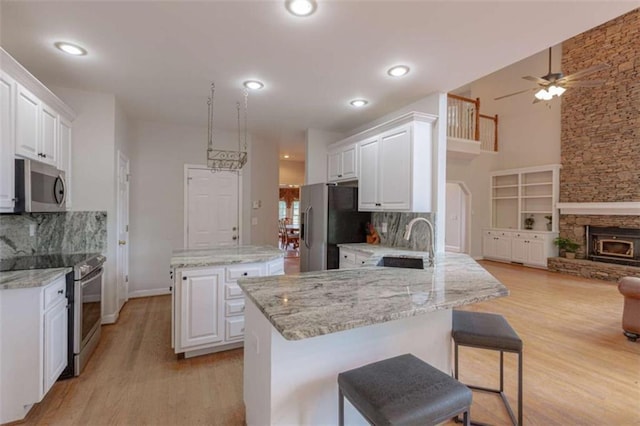 516 Turner Rd, Concord, GA 30206 - kitchen featuring stainless steel appliances, a center island, a ceiling fan, a sink, and light wood-style flooring