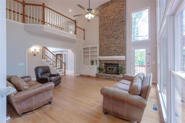 516 Turner Rd, Concord, GA 30206 - living area featuring a towering ceiling, arched walkways, stairs, light wood finished floors, and baseboards