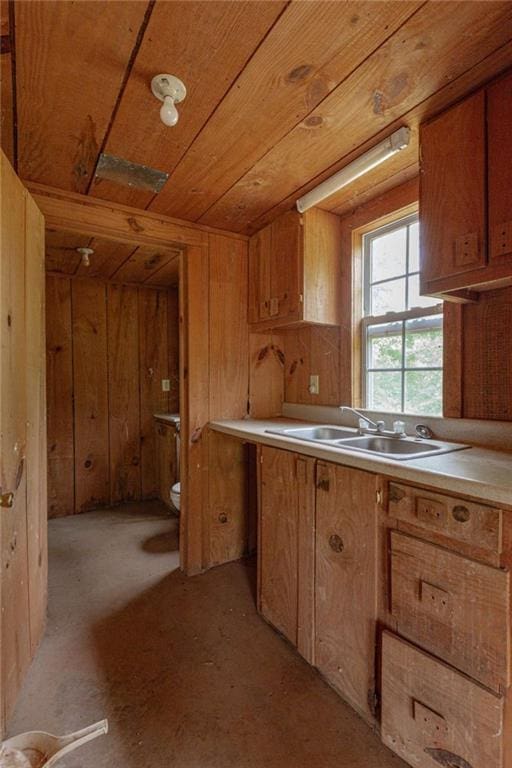 516 Turner Rd, Concord, GA 30206 - kitchen featuring a sink, wooden ceiling, wooden walls, brown cabinetry, and light countertops