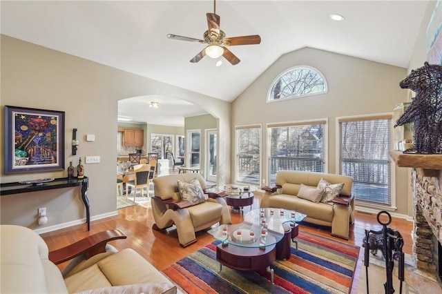 living room featuring vaulted ceiling, ceiling fan, and light hardwood / wood-style floors